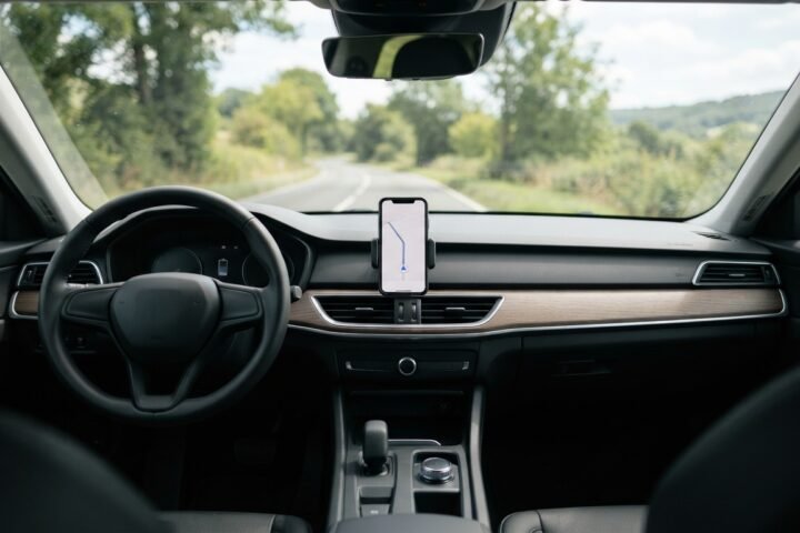 A smartphone mounted on a car dashboard for navigation purposes.